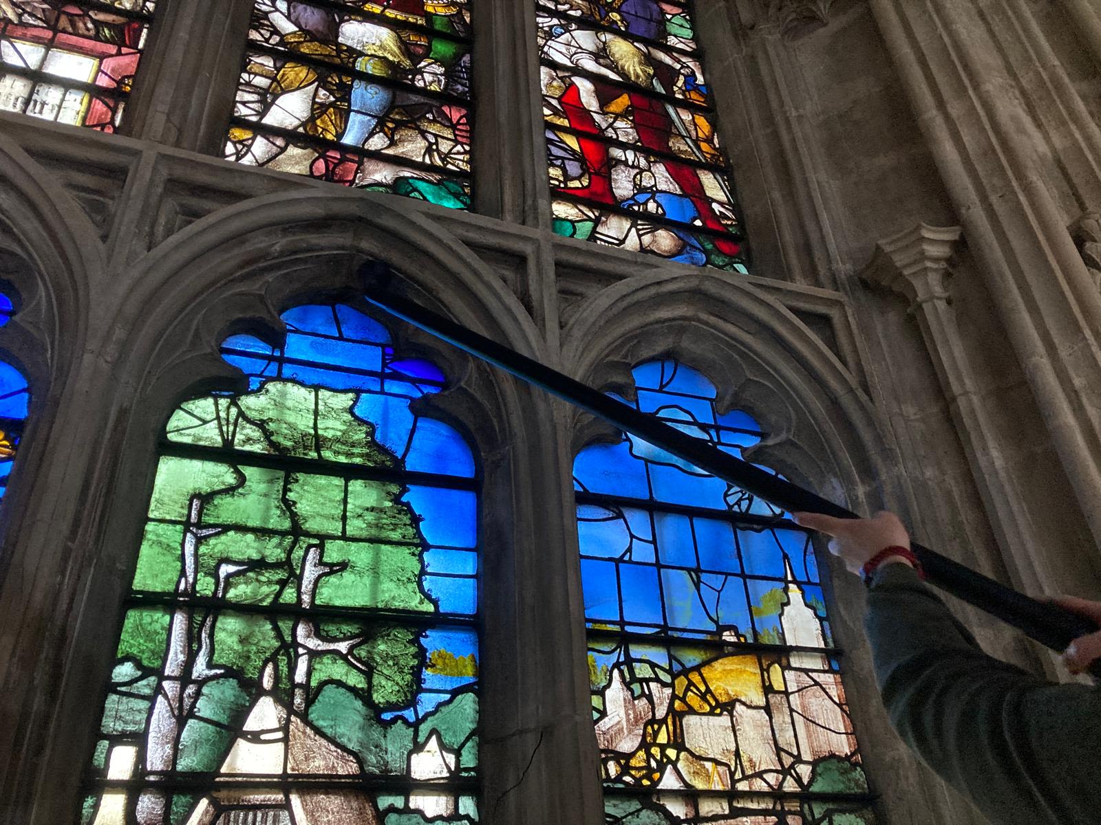 Stained glass windows being cleaned wtih a telescopic device