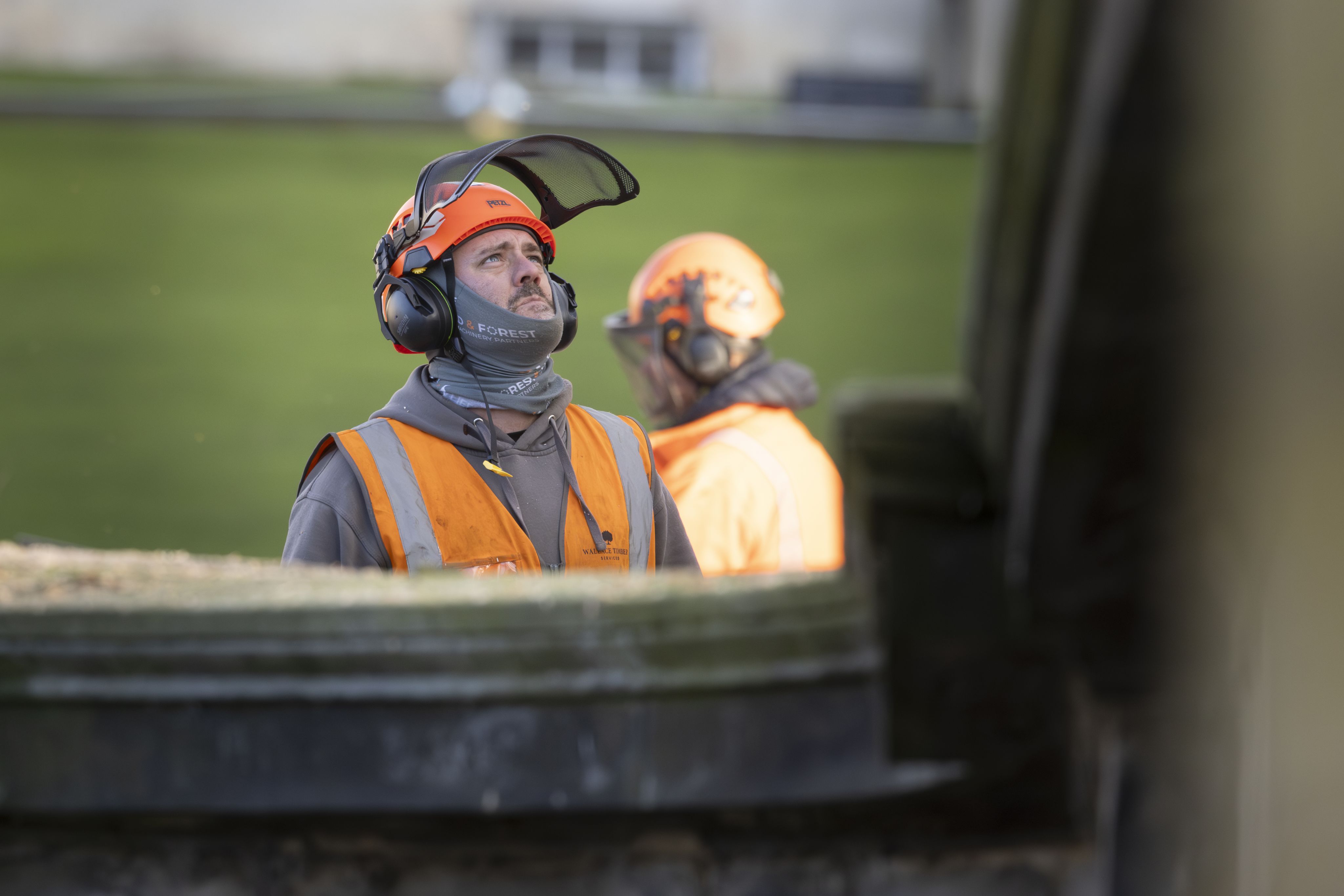 A man in protective equipment looks up