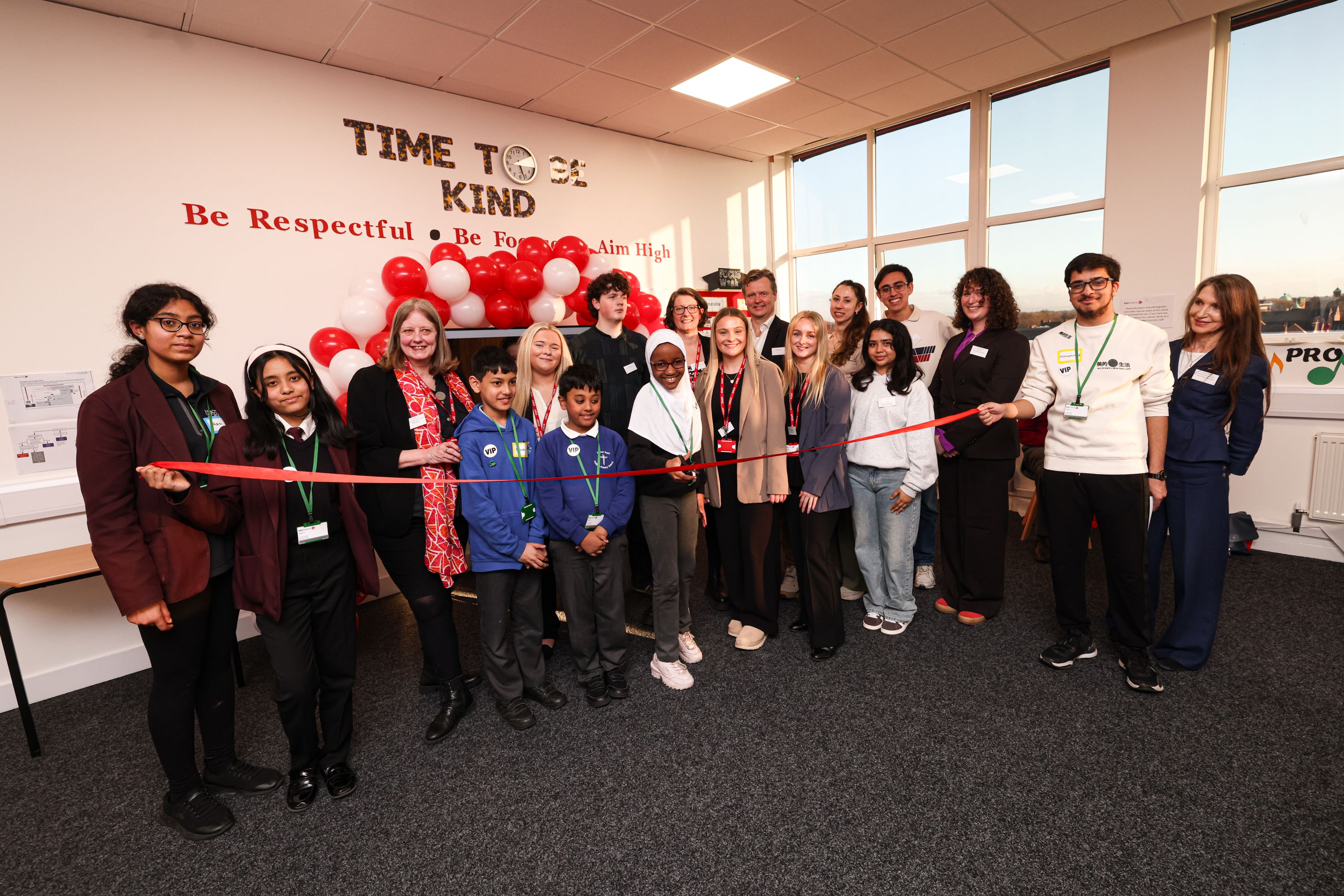 a group of students cuts a ribbon
